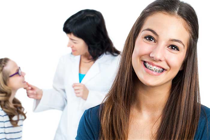 Young girl wearing braces smiling