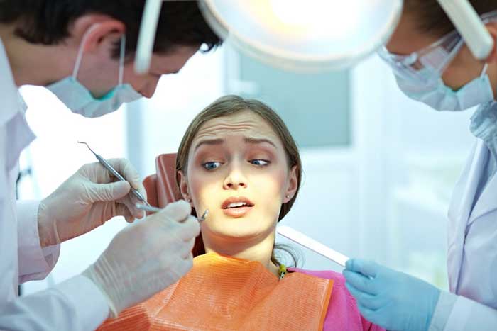 A girl is scared while treating teeth