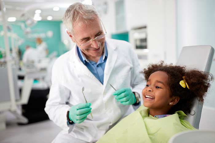 Dentist treating small girl