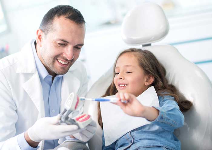 Dentist treating small girl