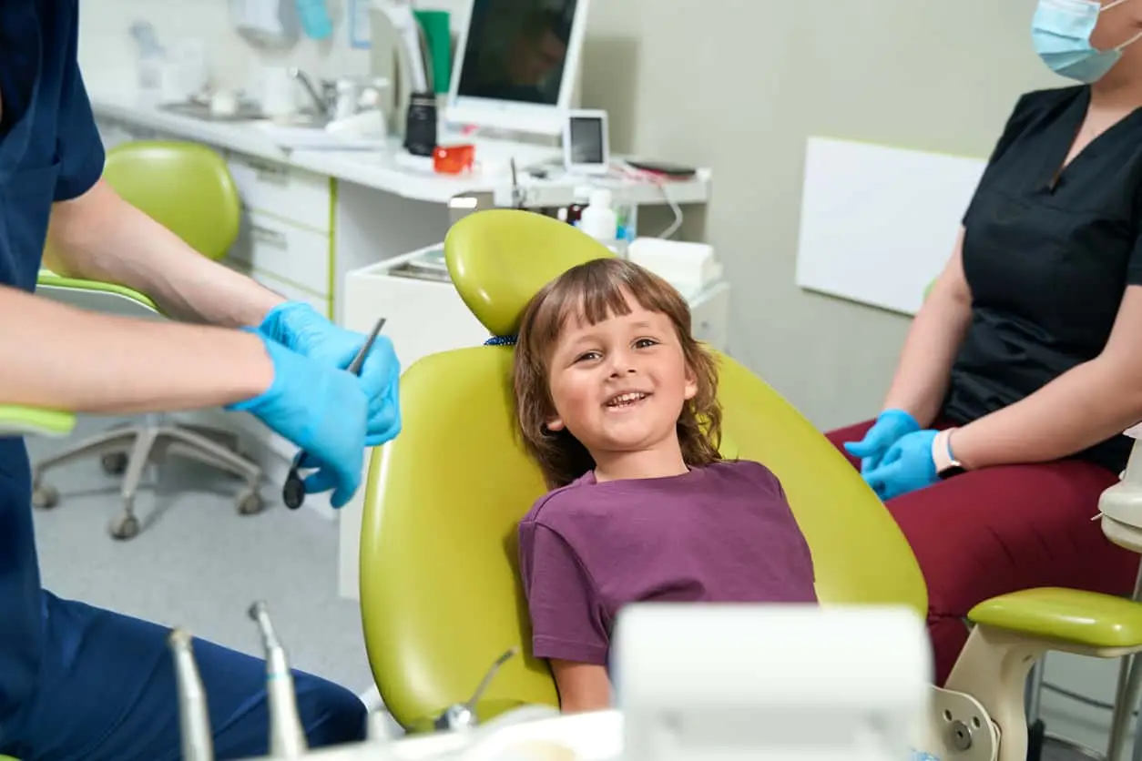 A young girl sitting in a dentist chair